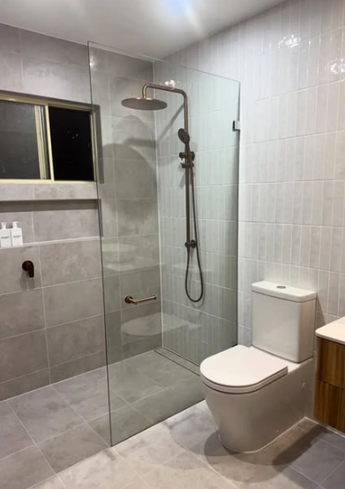 Grey tiled shower and bathroom completed by D.J.R